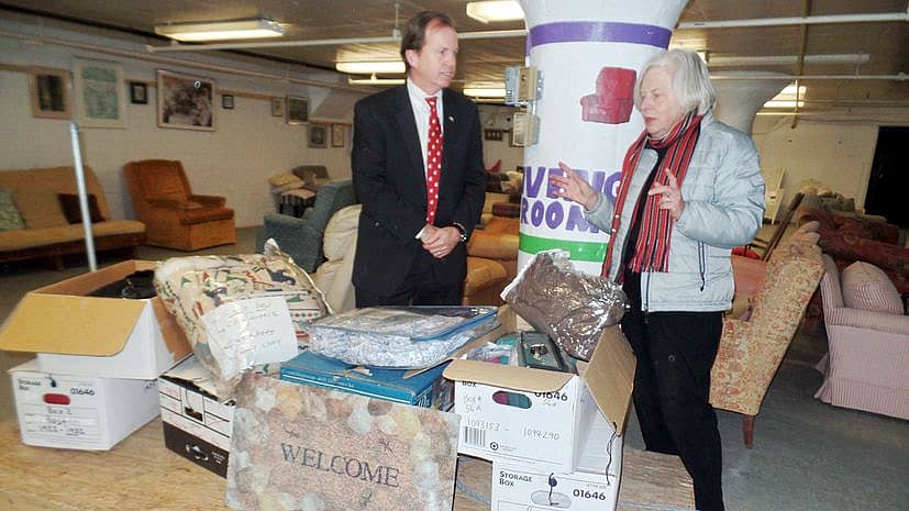 Bill O'Donnell talks with a woman about some of the donated items.