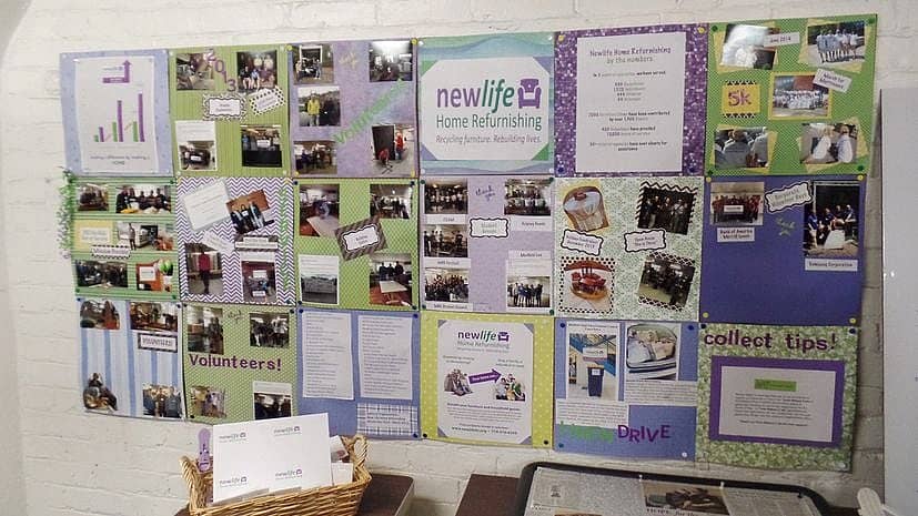 Bulletin board at the New Life Furniture Bank of MA showing many photos and other information.